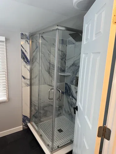 Bathroom remodeling with glass shower and marble tile