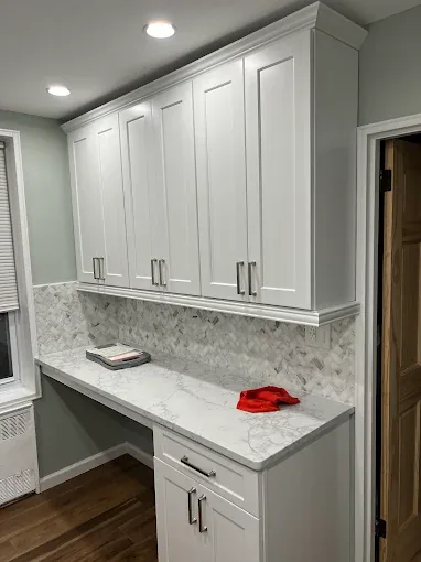 Custom white kitchen cabinets and marble countertop