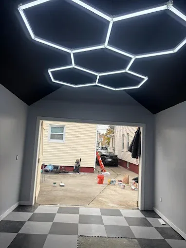 Garage remodel featuring hexagonal LED ceiling lighting viewed from the entrance