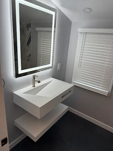 Modern bathroom vanity and illuminated mirror