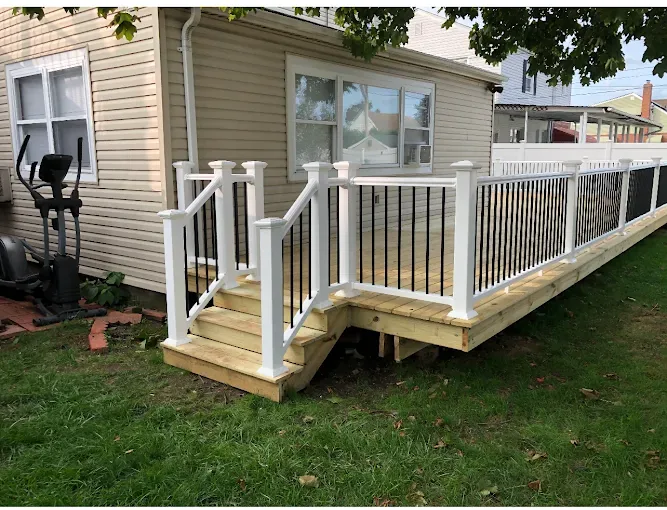Elevated deck with white railing and black balusters