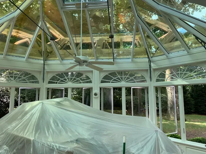 Sunroom interior with glass roof and large windows